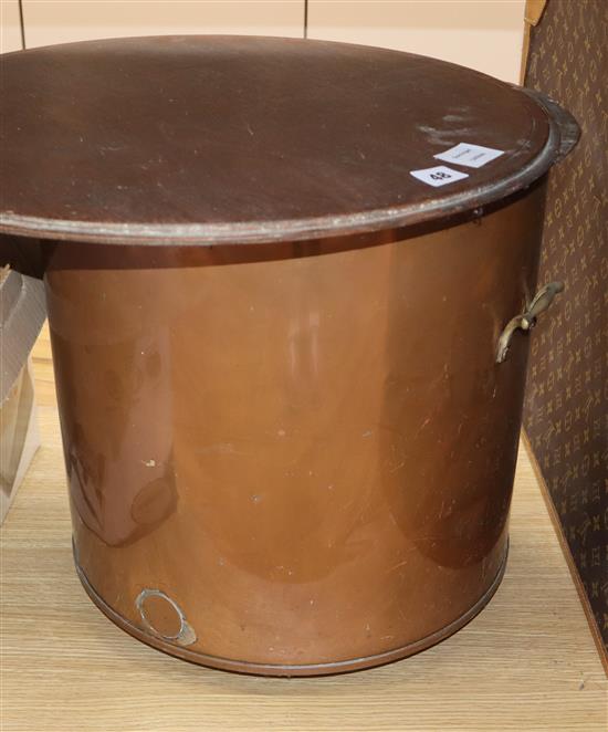 A copper coal bin with wood top